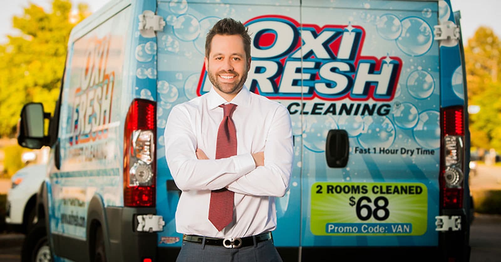 Oxi Fresh team member in front of an Oxi Fresh cleaning van